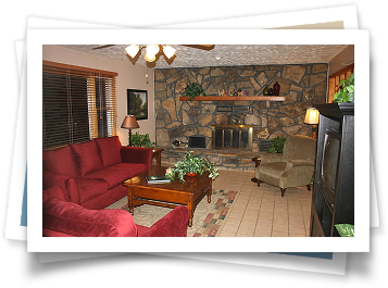 A living room with red furniture and a fireplace