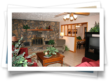 A living room with red furniture and a fireplace