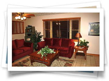 A living room with red couches and a coffee table