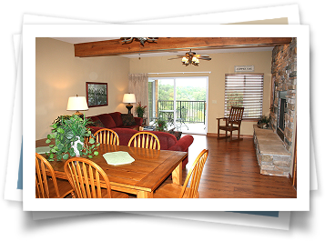 A living room with a table and chairs and a fireplace