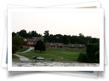 A picture of a lake with houses in the background