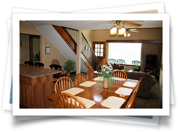 A picture of a living room with a dining table and chairs