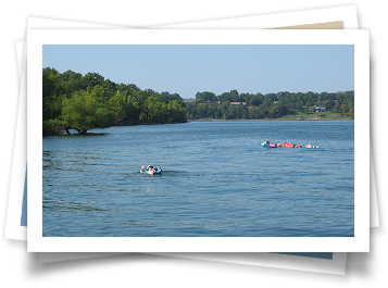 A group of people are floating on rafts in a lake