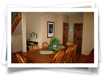 A picture of a dining room with a table and chairs