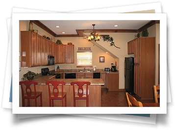 A kitchen with wooden cabinets and a black refrigerator