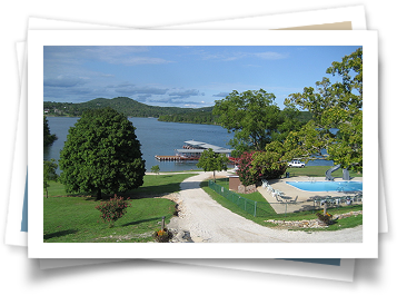 A picture of a lake with a dock and a swimming pool