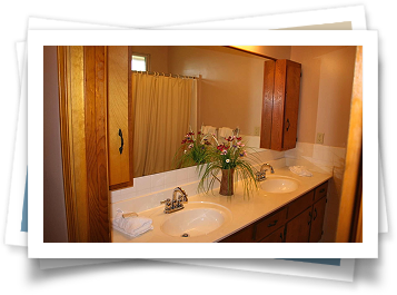 A bathroom with two sinks and a large mirror