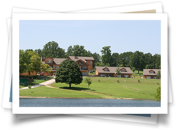 A picture of a house with a lake in front of it