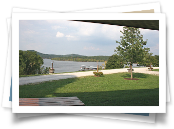 A picture of a lake with a picnic table in the foreground