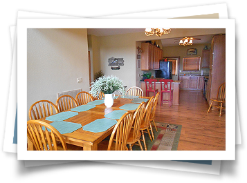 A picture of a dining room with a table and chairs