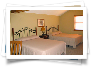 A hotel room with two beds and a window