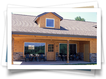 A picture of a log cabin with a porch