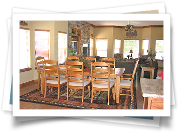 A picture of a dining room with a table and chairs