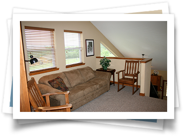 A living room with a couch and two chairs