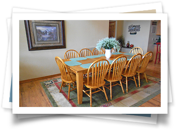 A picture of a dining room with a table and chairs