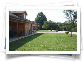 A picture of a house with a large lawn in front of it