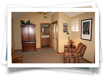 A picture of a living room with a chair and a dresser