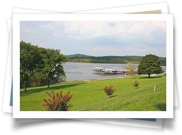 A picture of a lake with a dock in the distance