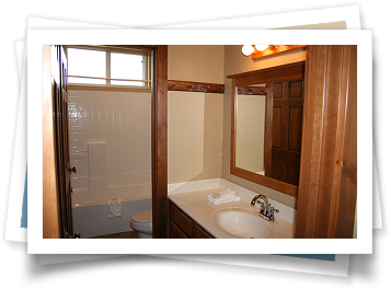 A bathroom with a sink , toilet and shower.