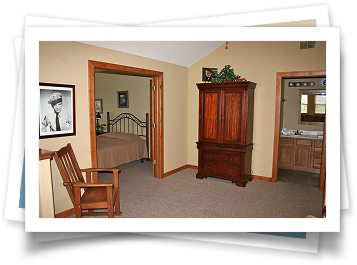 A picture of a bedroom with a chair and dresser