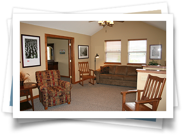 A living room with a couch and two chairs