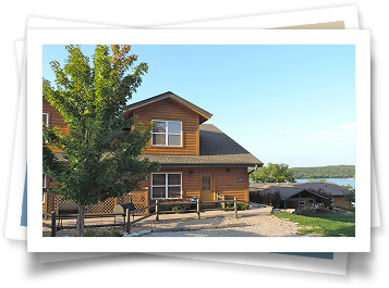 A picture of a house with a lake in the background