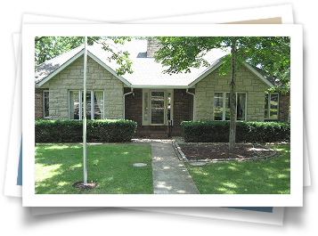 A picture of a brick house with a white roof