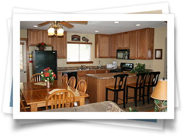 A kitchen with a table and chairs and a refrigerator