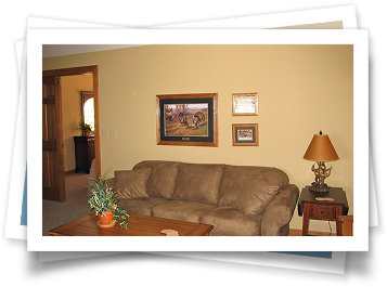 A living room with a brown couch and a lamp