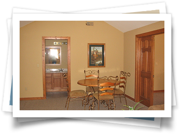 A picture of a dining room with a table and chairs