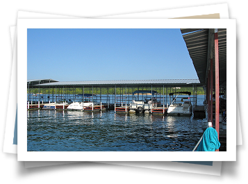 Several boats are docked at a marina on a sunny day