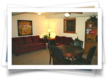 A living room with a red couch and a table