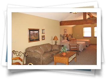 A living room with a couch and two beds