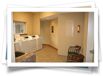 A picture of a laundry room with a fire extinguisher on the wall