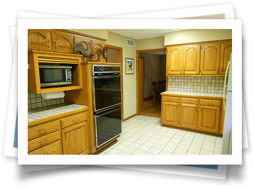 A kitchen with wooden cabinets and stainless steel appliances