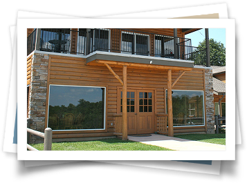 A picture of a wooden house with a balcony