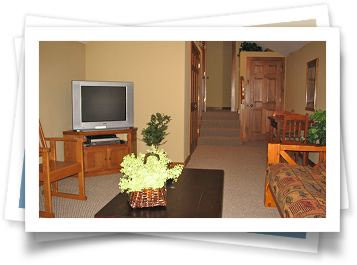 A living room with a flat screen tv on a stand