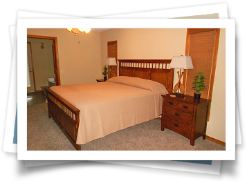 A bedroom with a king size bed and two nightstands