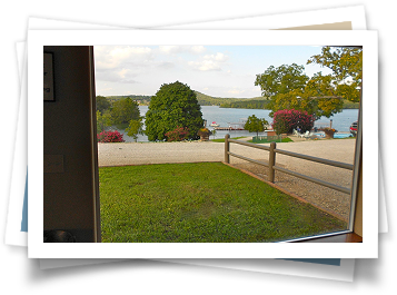 A picture of a yard with a lake in the background