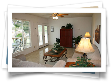 A living room with a couch a table and a lamp