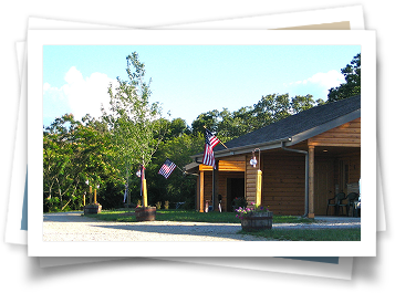 A picture of a house with american flags on the porch