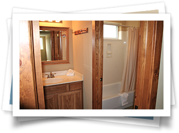 A bathroom with a sink , mirror , tub and shower.