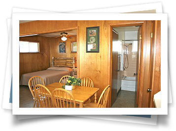 A picture of a bedroom with a table and chairs