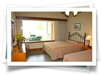 A hotel room with two beds and a large window