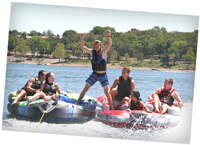 A group of people are riding tubes on a lake.