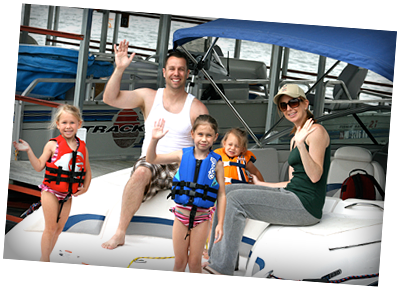 A family posing for a picture on a boat that says track