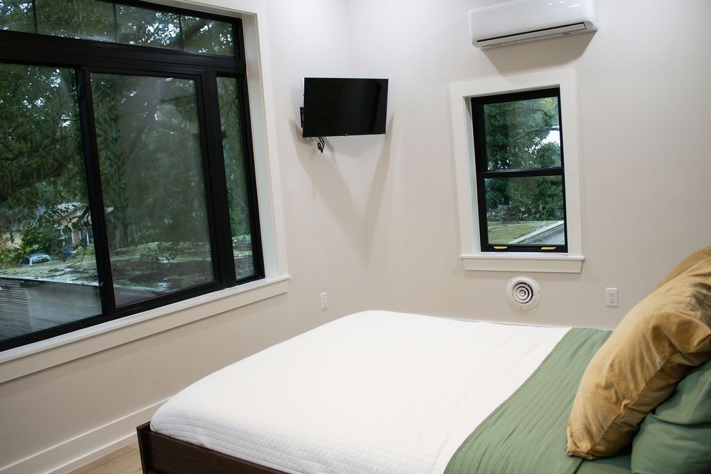 There is a table and a bench in the corner of the room.