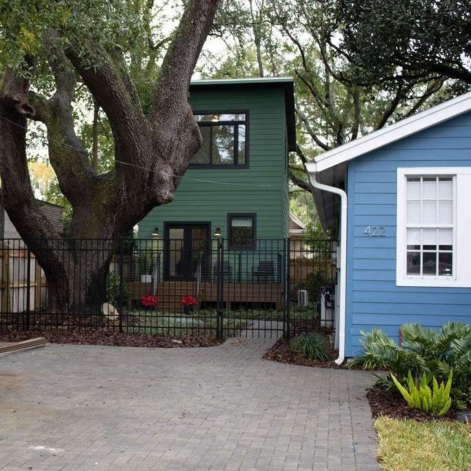 A house with a large window and stairs leading up to it.