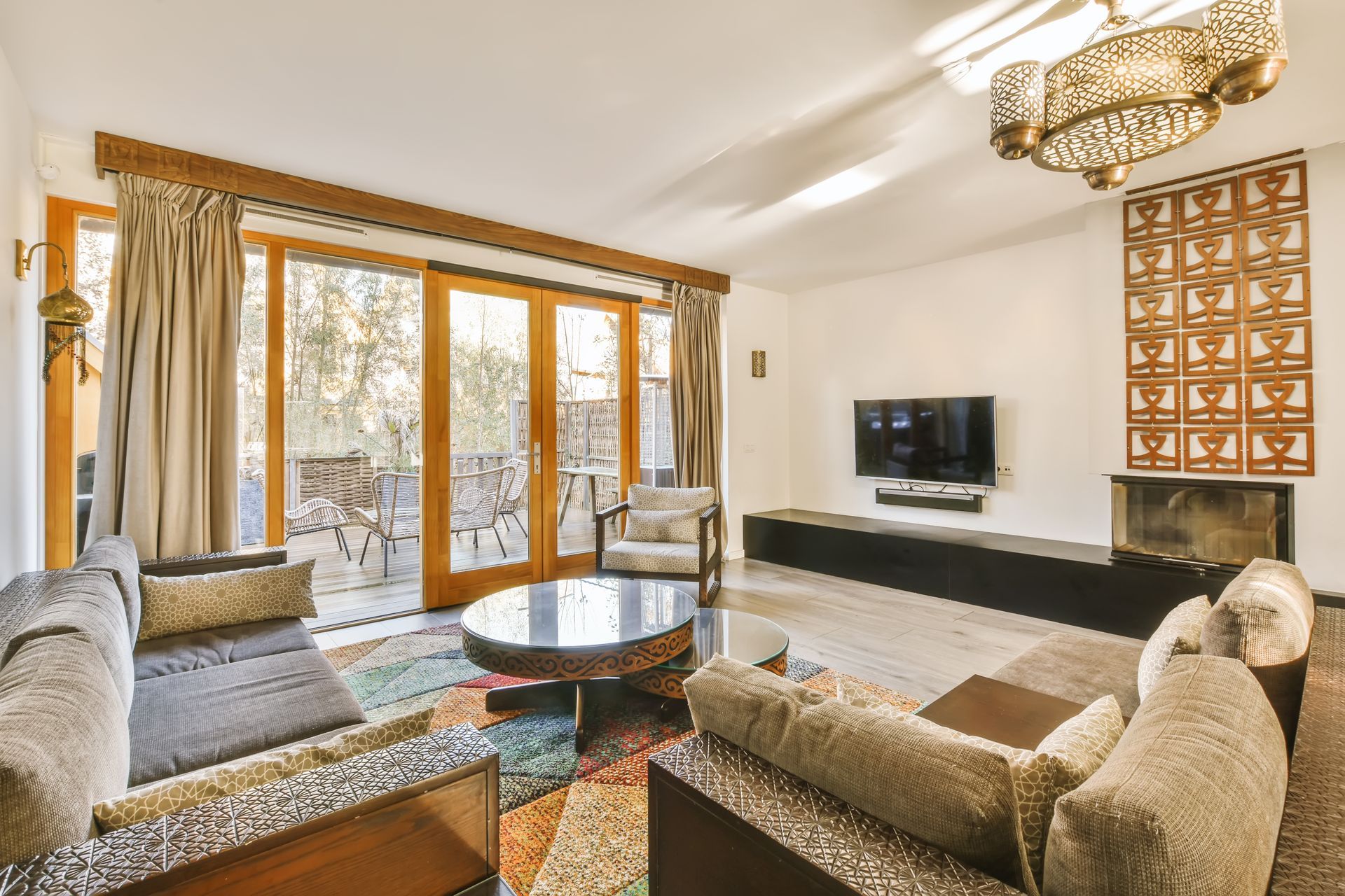 Living room with a sofa, round coffee table, TV, and balcony access.