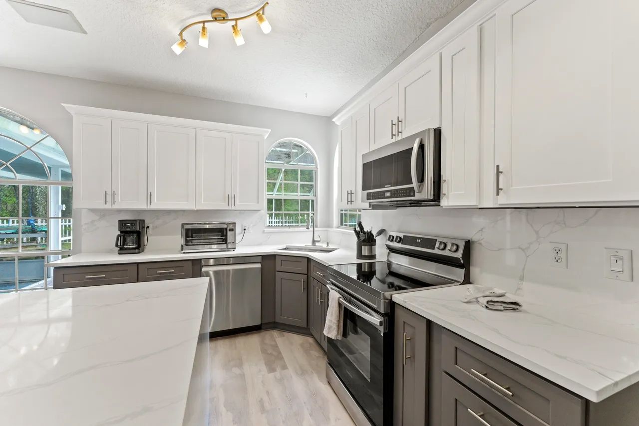 a kitchen with stainless steel appliances and white cabinets